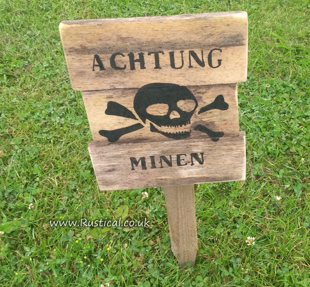 Wooden 'Achtung Minen' sign