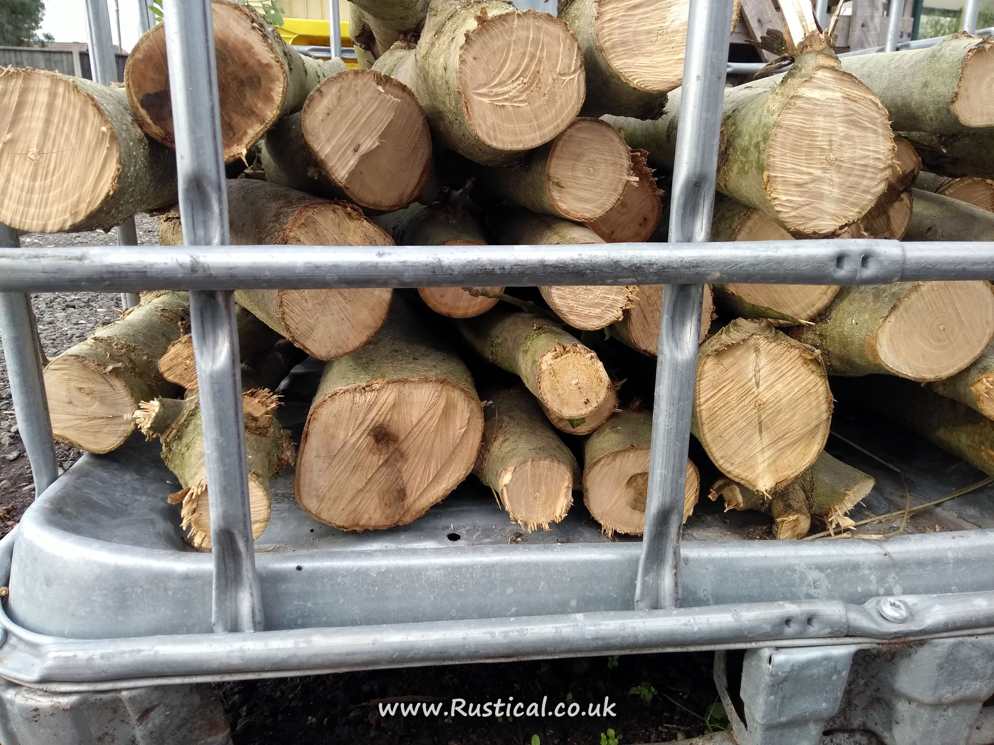 Coppiced Ash stacked in an IBC crate to season